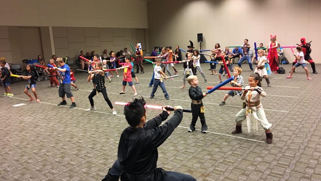 The Phoenix Lightsaber Academy hosted a workshop for children ages 6 and older, teaching them how to use foam sabers at Phoenix Comicon on May 25, 2017.