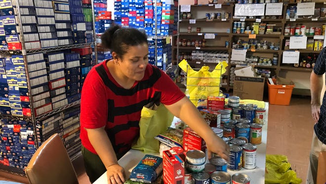 Home Away from Home's Mary Van Saders sorts and bags items at Nutley Family Service Bureau's Food Pantry.
