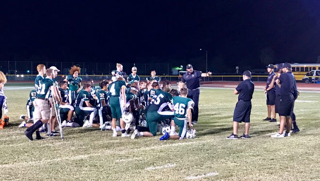 Greenway coach Ed Cook talks to his players after their homecoming win Friday night.
