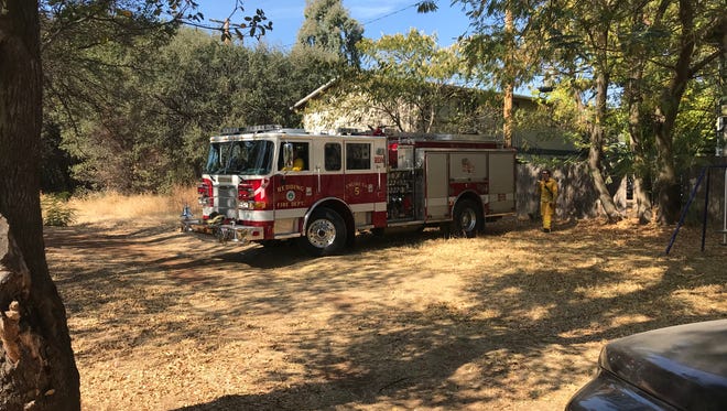 Redding firefighters put out a small grass fire off Churn Creek Road in Redding on Monday afternoon. While rain is expected later this week, fire officials said it is likely to do little to ease the extreme fire danger in the area.