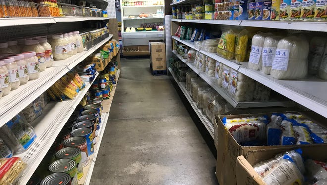 Shelves stocked full of groceries at a grocery store.