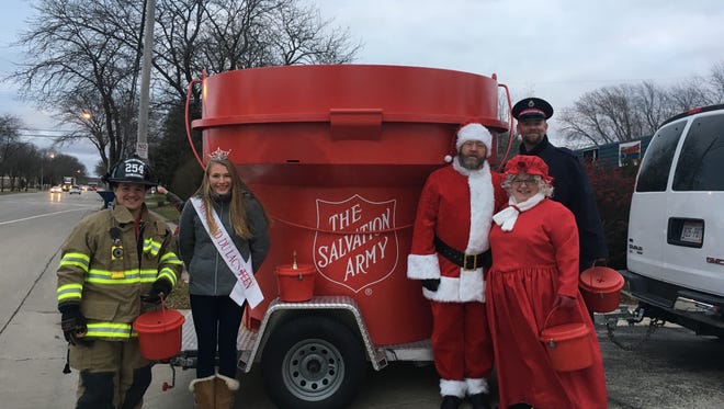 Standing from left, 2016 Bucket Brigade members Fond du Lac Firefighter Fire and Rescue Firefighter/Paramedic. Sean White, Miss Fond du Lac Teen, Santa and Mrs. Claus, and Fond du Lac Salvation Army Captain Steven Wilson gather around the King-sized Red Kettle. Last year, the Bucket Brigade raised a record $17,162.  This year's Bucket Brigade collection adds a south main street location.