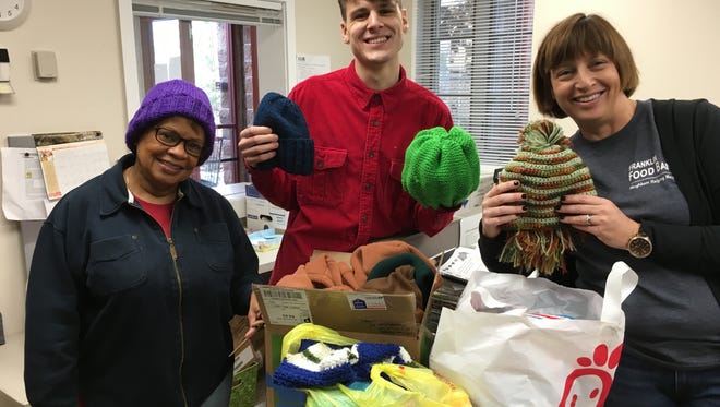 Ellen Zimmerman, right, and two of her staff at the Franklin Township Food Bank, display some of the hats you made that will be given to their clients in the coming days.