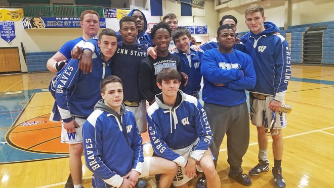 Williamstown wrestlers celebrate Wednesday's 40-12 win over Highland.