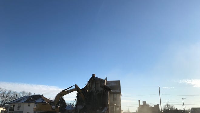 Crews demolish a house at 510 and 512 S. Minnesota Ave.