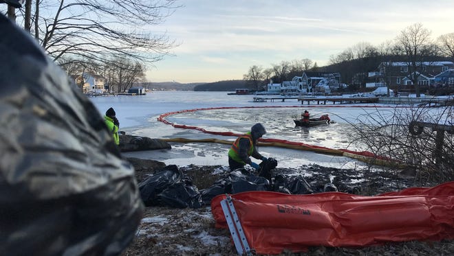 Workers remove diesel fuel contaminated ice and debris from Lake Hopatcong in New Jersey following a Feb. 4 report of a spill that state officials say likely emanated from a nearby construction firm.
