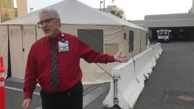 Kaweah Delta Assistant Chief Nursing Officer Daniel Allain stands in front of the hospital's second tent aimed to help with patients coming in by ambulance.