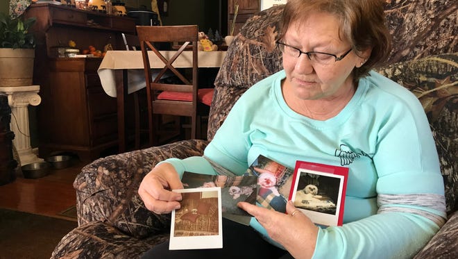 Patsy Pilgrim, of Six Mile, looks through pictures of her dog, Sophie, killed in February during an attack by a neighbor's pit bull.