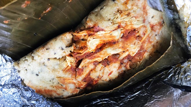 The food truck Taqueria La Vecindad sells two kinds of tamales, steamed in banana leaves and wrapped in foil: chicken (shown) and pork.
