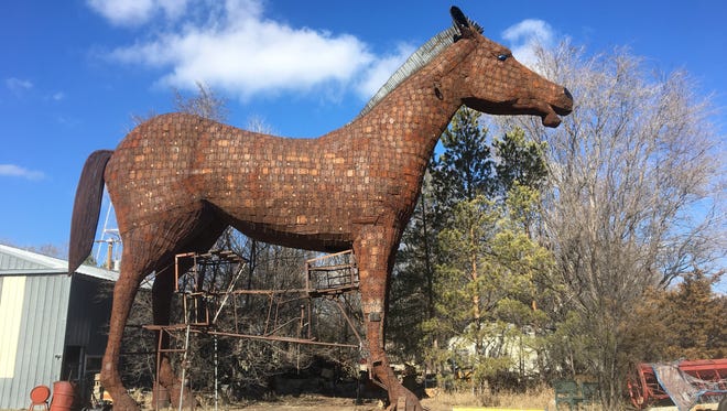 Wayne Porter's completed giant steel horse stands outside his blacksmith shop in St. Lawrence, awaiting its 130-mile move to Porter's sculpture park.