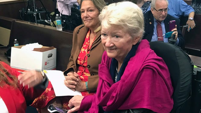 In this May 16, 2018 photo, Cathy Jordan, right, who has been suffering from ALS since 1987, looks on after completing testimony in Tallahassee, Fla., that would declare a smoking ban on medical marijuana unconstitutional in Florida. A Florida judge on Friday, May 25, 2018, ruled that the ban is unconstitutional.