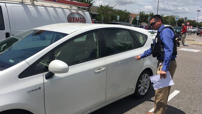 Prattville Police Department Investigator Wesley Clark checks for unlocked vehicles at a Prattville business parking lot.