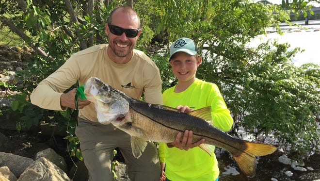 Derek and Denton Potter of Palm City spent Father's Day catching snook at a spillway in Jupiter using Flair City hairy mullet jigs.