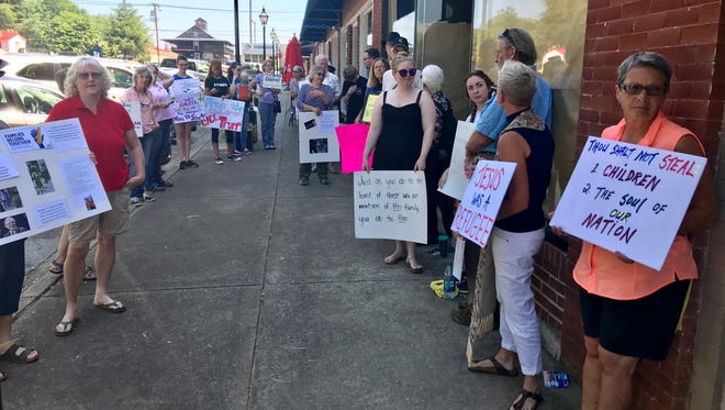 About 30 people gather in front of U.S. Sen. Lindsey Graham’s office in Pendleton on Tuesday to protest the Trump administration’s policy of separating children from their parents who are seeking at the to enter the country at the Mexican border.