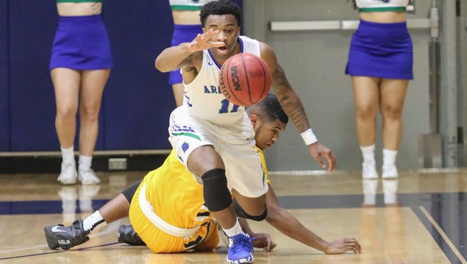 West Florida's Rashaan Benson (11) steals the ball from Mississippi College's Brandon Boston (2) during a conference game Thursday night at UWF.