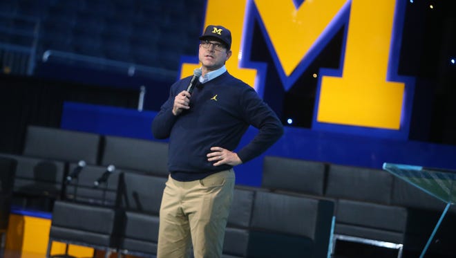 Michigan head coach Jim Harbaugh talks with fans during the Signing of the Stars event at the Crisler Center in Ann Arbor on Wednesday, Feb. 1, 2017.