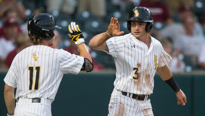 Southern Miss' Daniel Keating (3) celebrates after scoring during the fourth inning against Dallas Baptist during an NCAA college baseball tournament regional game Friday, June 1, 2018, in Fayetteville, Ark. (Ben Goff/The Northwest Arkansas Democrat-Gazette via AP)
