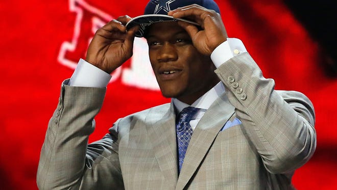 Nebraska defensive lineman Randy Gregory celebrates after being selected by the Dallas Cowboys as the 60th pick in the second round of the 2015 NFL Football Draft,  Friday, May 1, 2015, in Chicago.