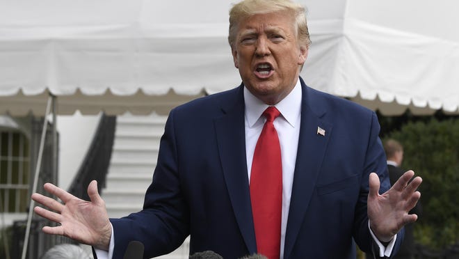 President Donald Trump talks to reporters last week on the South Lawn of the White House.