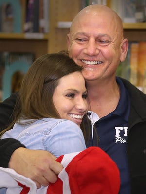 Jimbo Jackson embraces his daughter, Ashley, after being named the Tallahassee Democrat's Person of the Year for 2013.