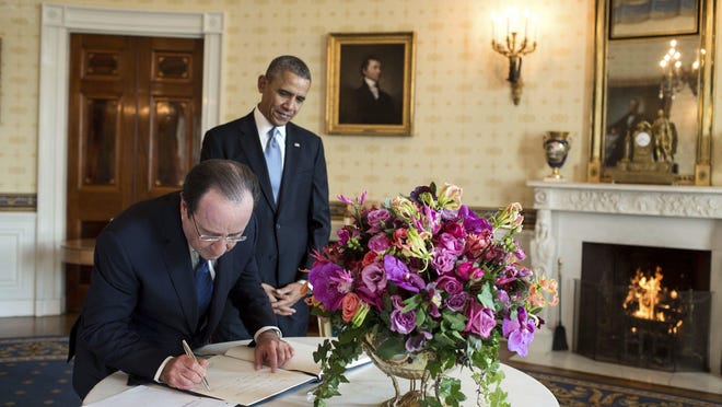French President François Hollande and President Barack Obama. A centerpiece bouquet of early spring flowers in the French style is presented in a gilded pedestal Vermeil vase.