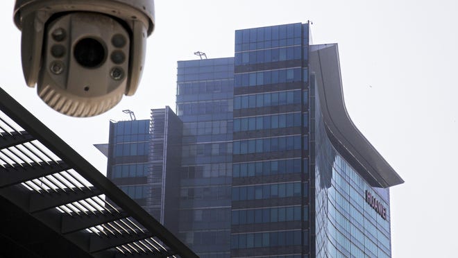 In this Dec. 18, 2018, photo, a surveillance camera is mounted near the Huawei headquarters in Shenzhen in south China's Guangdong province.