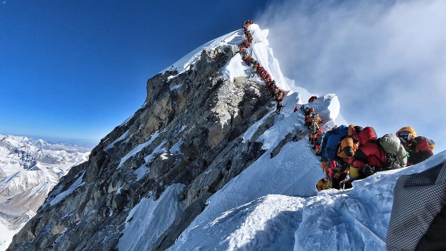 In this file handout photo taken on May 22, 2019 and released by climber Nirmal Purja's Project Possible expedition shows heavy traffic of mountain climbers lining up to stand at the summit of Mount Everest.