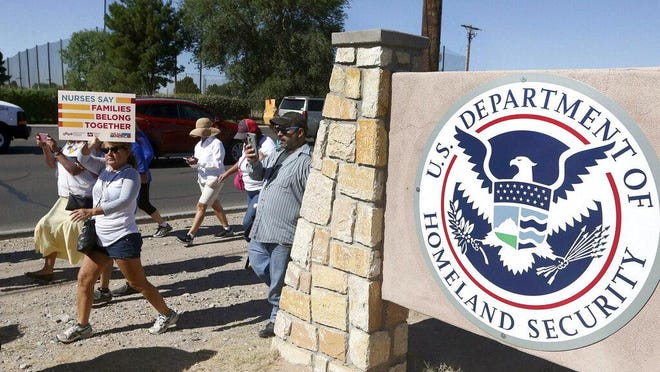 This June 2018 file photo shows protesters walking along Montana Avenue outside the El Paso Processing Center, in El Paso, Texas. The U.S. government has suddenly stopped force-feeding a group of men on a hunger strike inside a Texas immigration detention center, U.S. Immigration and Customs Enforcement said Thursday, Feb. 14, 2019. The dramatic reversal comes as public pressure was mounting on ICE to halt the practice, which involves feeding detainees through nasal tubes against their will.