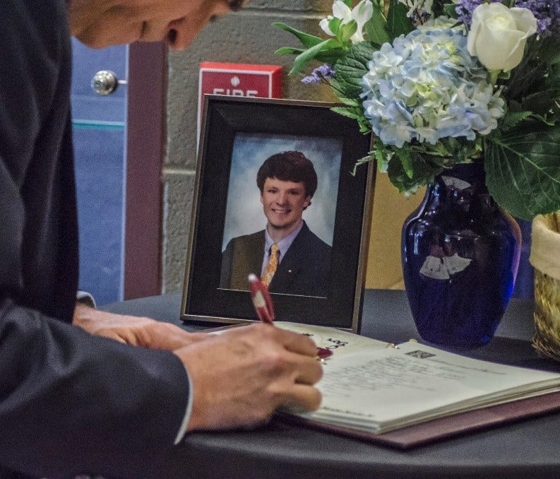 A visitor signs the condolence book during the funeral service of Otto Warmbier in Wyoming, Ohio, on June 22. Otto Warmbier died on June 19 in his hometown of Wyoming, a suburb of Cincinnati, a few days after his return from North Korea.
