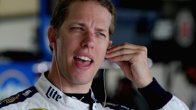 Brad Keselowski, driver of the #2 Miller Lite Ford, stands in the garage area during practice for the NASCAR Sprint Cup Series Pure Michigan 400 at Michigan International Speedway on August 27, 2016 in Brooklyn.