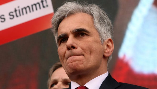Werner Faymann listens to a speech in Vienna on May 1.