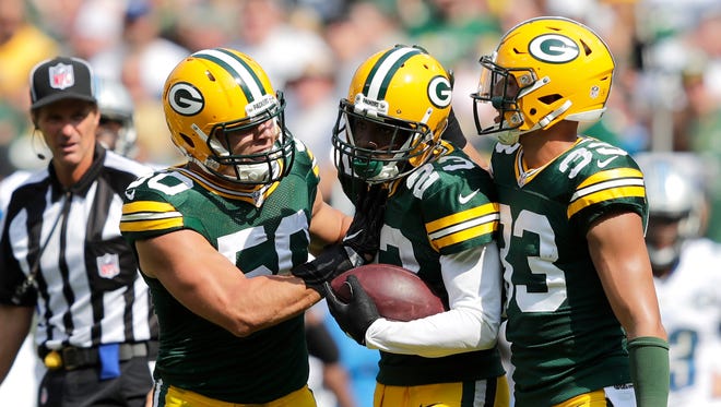 Green Bays' Damarious Randall celebrates a defensive play with Blake Martinez, left, and Micah Hyde, right, during a game in 2016.