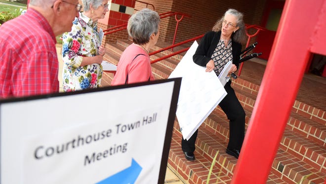 Susan Read of the anti-referendum group Common Sense Courthouse stands on the front steps with information on a proposal already presented on renovating the current courthouse under her arm. She pauses to talk with people arriving before the start of a courthouse referendum town hall meeting held at Riverheads High School on Monday, Sept. 19, 2016.