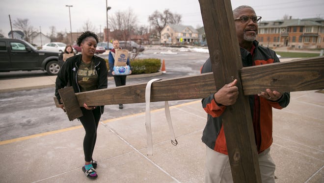 Hubert Tyler and his daughter Krysten bring a cross into Grace Apostolic Church in the Kennedy-King neighborhood of Indianapolis. April 4 marks the 50th anniversary of Martin Luther King Jr.'s assassination and the day Robert  F. Kennedy spoke of it in Indianapolis.