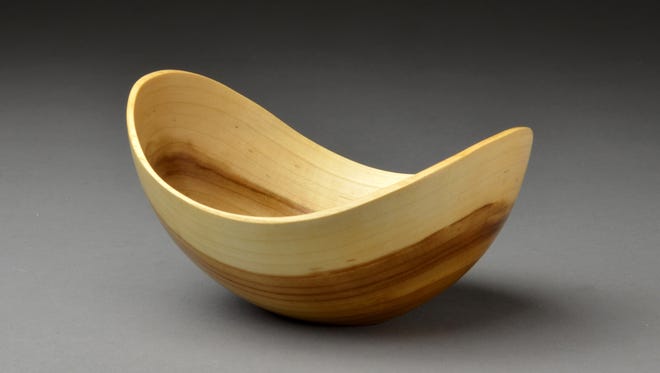 Bowl-shaped art called Turning Trees, by Bob Jensen, is an example of the art sought in a juried show.