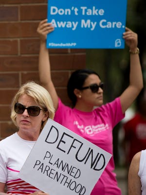 An opponent and supporter of Planned Parenthood demonstrate on July 28, 2015, in Philadelphia.