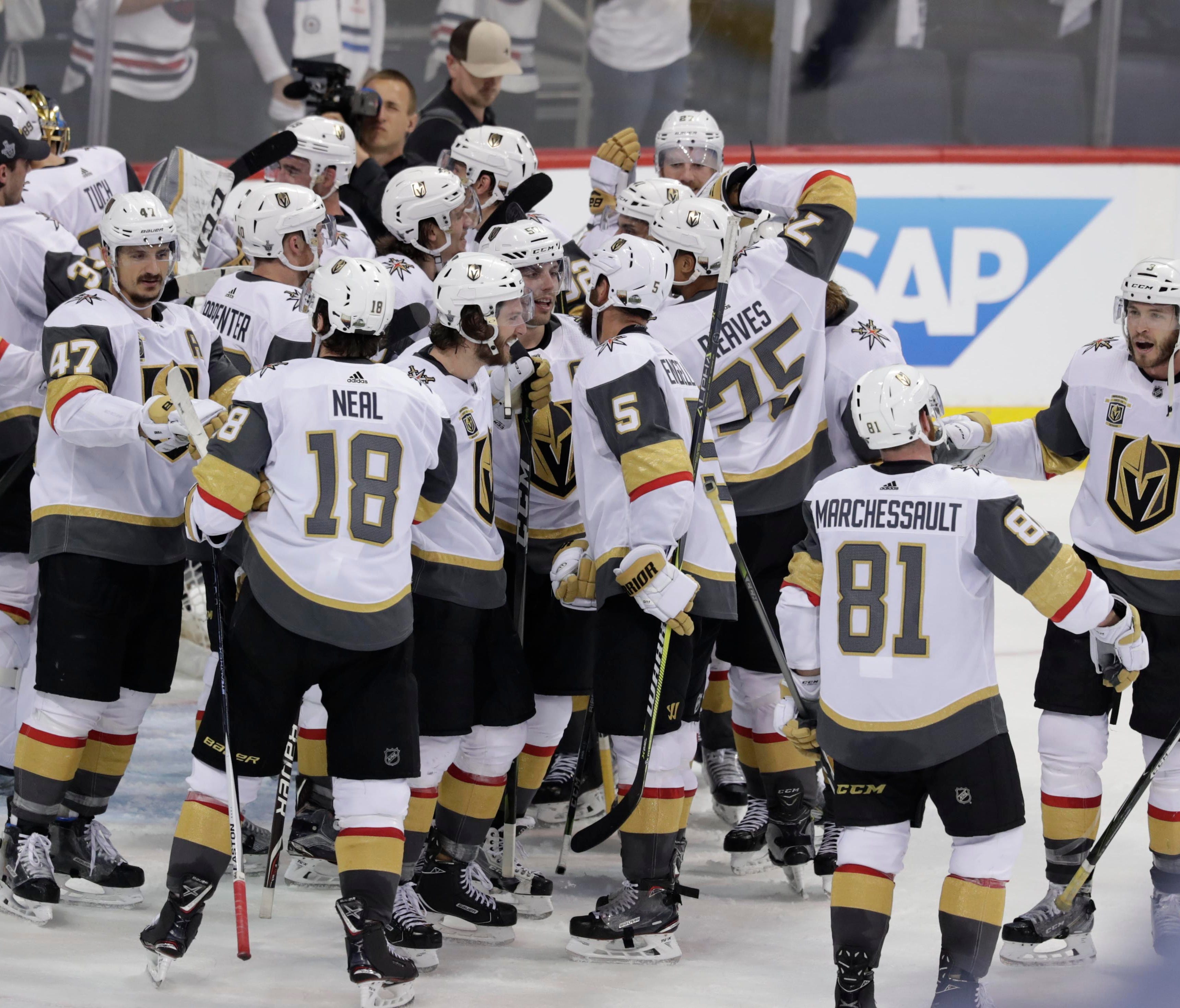 Vegas Golden Knights players celebrate after defeating the Winnipeg Jets to reach the Stanley Cup Final.
