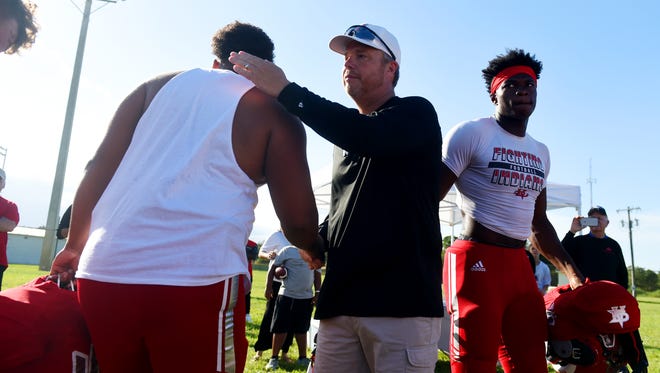 Joe Graves is offered a handshake and a hug from the entire Vero Beach football team on Friday, Aug. 18, 2017, during a tailgate party sponsored by the Jimmy Graves Foundation on the baseball field west of the Citrus Bowl in Vero Beach. "I would see small pockets of individuals sitting around their cars before each football game, and so we wanted to provide a place for people to come and meet together," Joe Graves said. "The tailgate is open to anyone in the community whether they're going to the game or just like the pregame activities." Graves said that they would like to host the tailgate party at each home game. Read more about Vero Beach's Kickoff Classic game Friday in Sports, Page 1C.