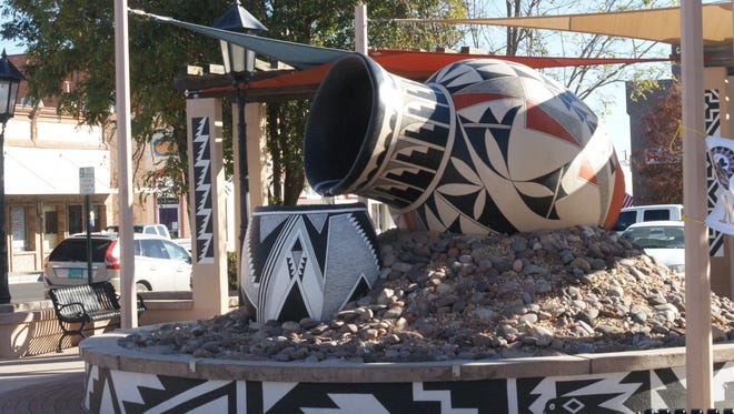 Deming-Luna County MainStreet renovated Leyendecker Plaza in downtown Deming to include a new fountain inspired by Mimbres pottery, pergolas with decorative art by Deming artist Jessie Kriegel, and sails providing shade for seating installed below.