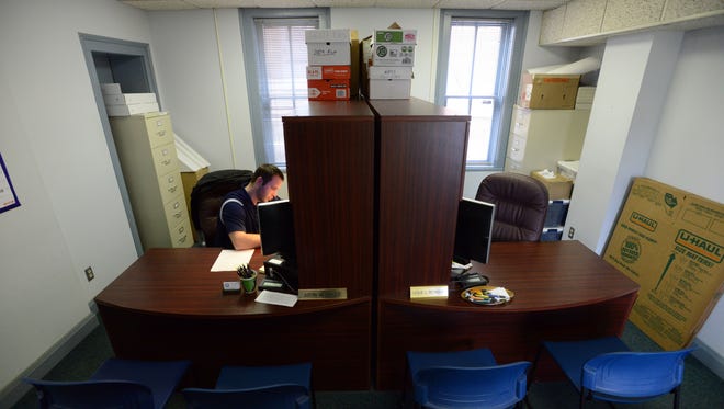 Justin Messinger works at his desk in a shared office at the Fairfield County Veterans Service Commission office in Lancaster. The office will move out of its cramped quarters to a space that’s about three times larger, on North Memorial Drive.