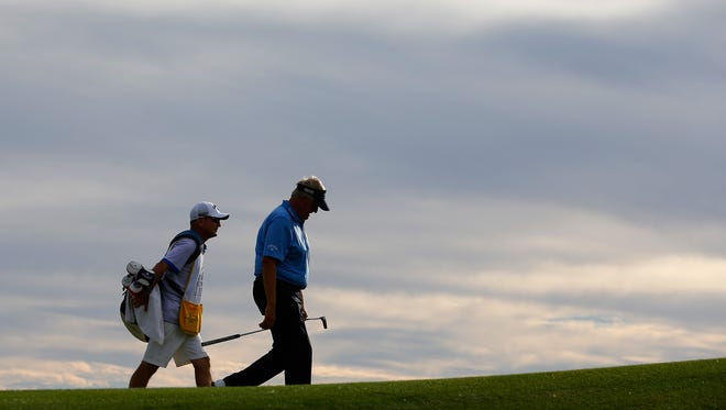 Colin Montgomerie walks down the 16th fairway with caddie Alastair McLean during the first round of the Charles Schwab Cup Championship on the Cochise Course at The Desert Mountain Club on Oct. 30, 2014 in Scottsdale, Arizona.