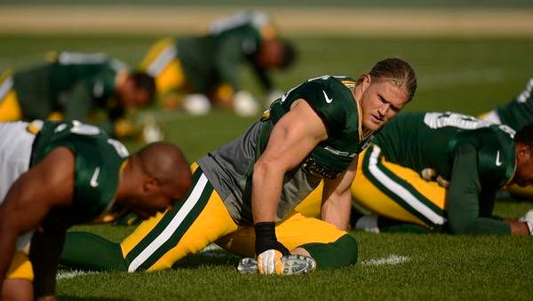 Green Bay Packers linebacker Clay Matthews stretches with his teammates during Monday's training camp practice at Ray Nitschke Field.