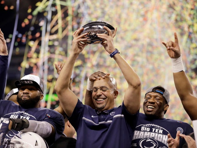 Penn State head coach James Franklin holds the trophy