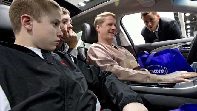 Pictured are Tom Oeters of West Chester and his sons Andrew and Josh. The 2017 Cincinnati Auto Expo's "Rev It Up" gala aims to raise funds to purchase children's seats as well as heighten awareness of car safety.