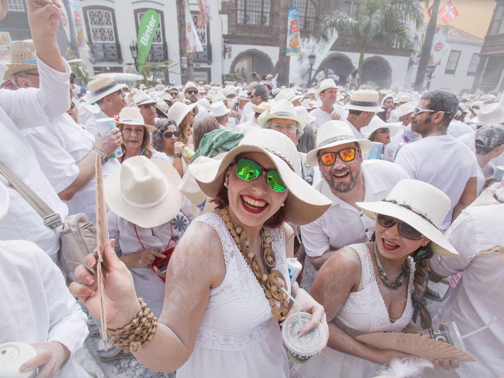 Revellers covered with talcum powder wait for promotional goodies during the street carnival 'Los Indianos' in Santa Cruz de la Palma, on the Spanish Canary island of La Palma, on Feb. 27, 2017.