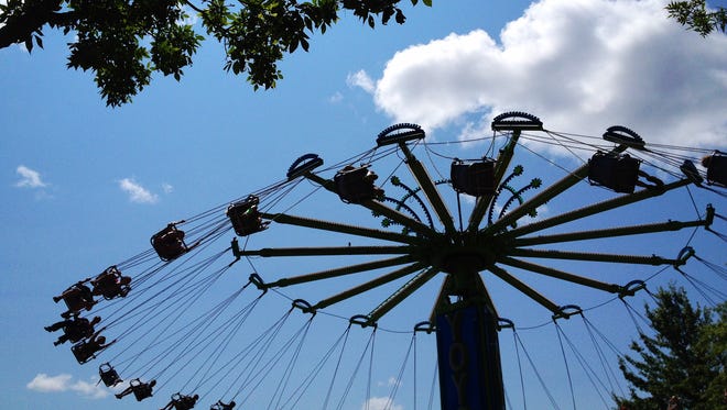 Fair-goers enjoy the swings in Wisconsin Valley Fair's Midway Thursday, July 31, 2014.