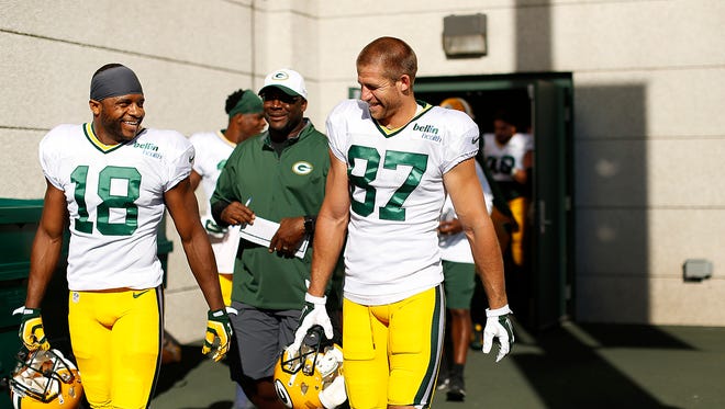 Green Bay Packers receivers Randall Cobb (18) and Jordy Nelson (87) are all smiles as they hit the field during training camp practice at Ray Nitschke Field on Saturday, Aug. 1, 2015.