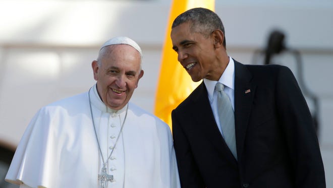 President Barack Obama leans over to talk to Pope Francis during a state arrival ceremony on the South Lawn of the White House in Washington, Wednesday, Sept. 23, 2015.