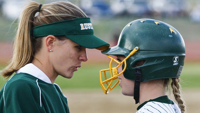 C.M. Russell head softball coach Lindsey Graham talks to one of her players at Multi-Sports Complex.