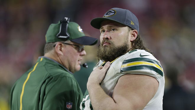 Green Bay Packers guard Josh Sitton (71) looks on from the sidelines in the fourth quarter against the Arizona Cardinals at University of Phoenix Stadium.